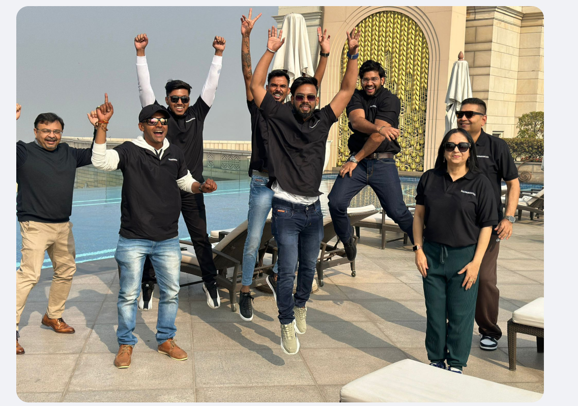 Panmedical team celebrating at the rooftop pool during the Delhi retreat