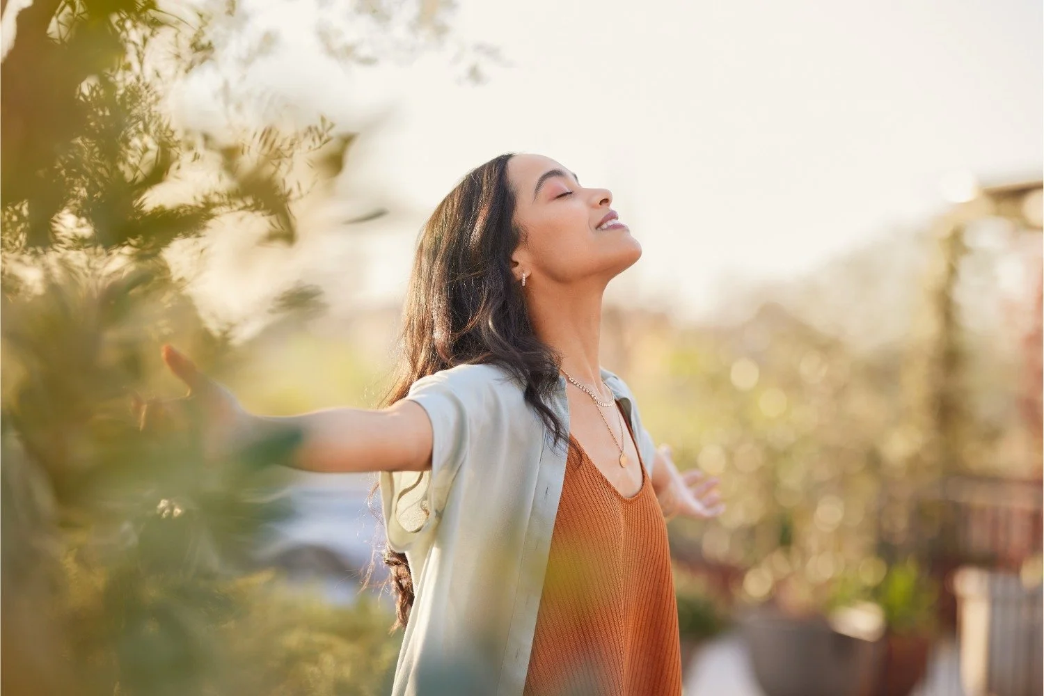 Woman feeling calm and at ease at sunset